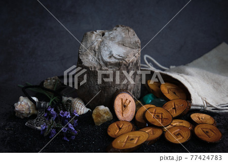 homemade wooden runes on a dark background 77424783