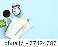 Still life, business, office supplies, meeting, planning, work from home or education concept : Top view or flat lay of notebooks, clock, coffee and pen on blue background, ready for adding or mock up 77424787