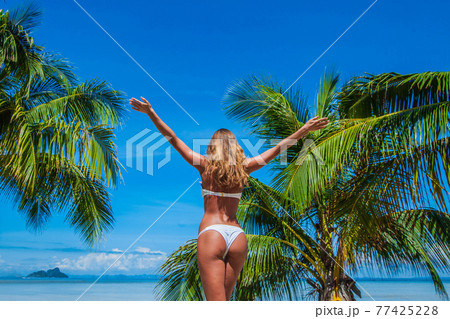 Woman in bikini enjoying tropical beach Woman in bikini enjoying tropical beach 77425228