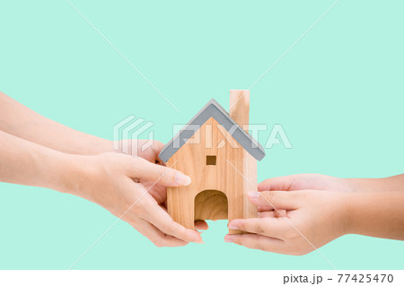 children hands and adult hands Holding housing and family concept 77425470