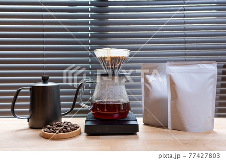Hand drip coffee, Barista making drip coffee with mockup blank package coffee Alternative ways of brewing Coffee shop concept 77427803