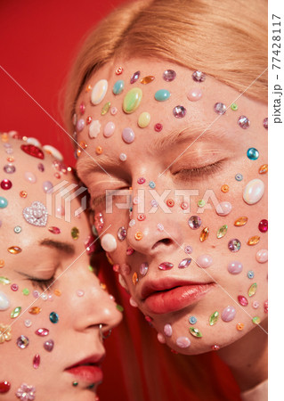 Albino man with long blonde hair bonding to bald unladylike female with piercing while posing 77428117
