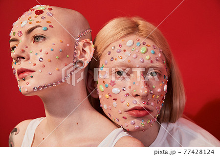 Masculine bald woman and feminine man bonding to each other 77428124