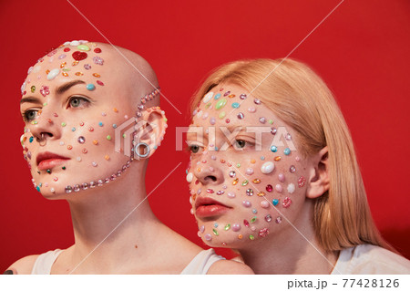 Womanly male with feminine features and masculine female with bald head looking away 77428126