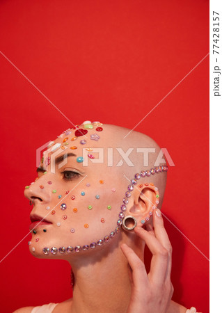 Bald woman with unladylike appearance looking away while posing Bald woman with unladylike appearance looking away while posing 77428157
