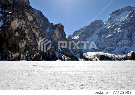 Rocks on frozen lake 77428908