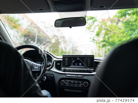 Interior of the car with a multimedia device on the dashboard.  77429574
