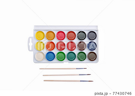 Multicolored aquarelle paints in paint box with brushes on white background. Multicolored aquarelle paints in paint box with brushes on white background. 77430746