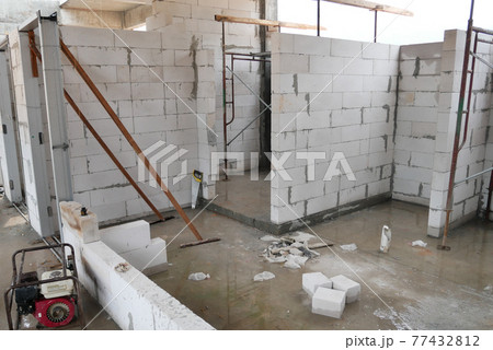 SEREMBAN, MALAYSIA -MARCH 19, 2021: Autoclaved aerated concrete block or known as AAC block used at the construction site. Install by workers using special mortar. Easy and fast.   77432812