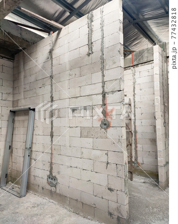 SEREMBAN, MALAYSIA -MARCH 19, 2021: Autoclaved aerated concrete block or known as AAC block used at the construction site. Install by workers using special mortar. Easy and fast.   77432818