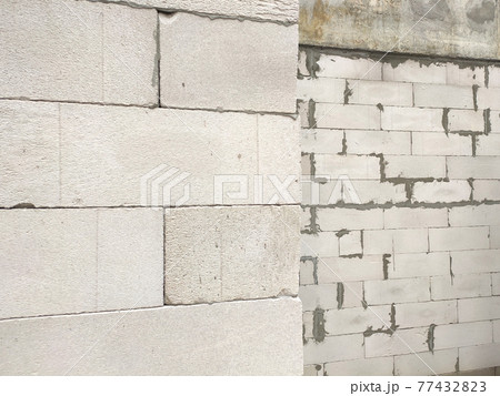 SEREMBAN, MALAYSIA -MARCH 19, 2021: Autoclaved aerated concrete block or known as AAC block used at the construction site. Install by workers using special mortar. Easy and fast. SEREMBAN, MALAYSIA -MARCH 19, 2021: Autoclaved aerated concrete block or known as AAC block used at the construction site. Install by workers using special mortar. Easy and fast. 77432823