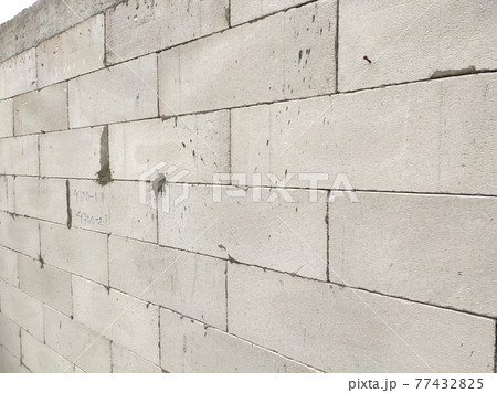 SEREMBAN, MALAYSIA -MARCH 19, 2021: Autoclaved aerated concrete block or known as AAC block used at the construction site. Install by workers using special mortar. Easy and fast.   77432825