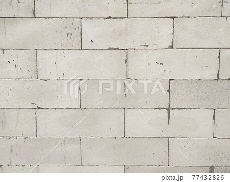 SEREMBAN, MALAYSIA -MARCH 19, 2021: Autoclaved aerated concrete block or known as AAC block used at the construction site. Install by workers using special mortar. Easy and fast. SEREMBAN, MALAYSIA -MARCH 19, 2021: Autoclaved aerated concrete block or known as AAC block used at the construction site. Install by workers using special mortar. Easy and fast. 77432826