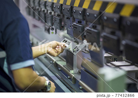 The technician operator working with hydraulic press brake bending machine. The technician operator working with hydraulic press brake bending machine. 77432866