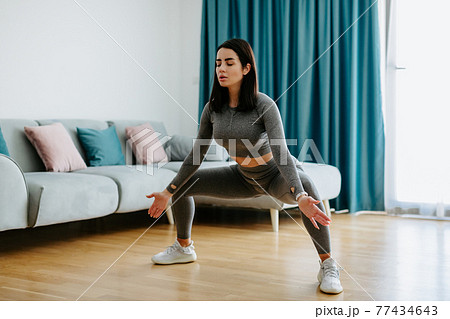 Young woman practicing yoga at home. stretching practice Young woman practicing yoga at home. stretching practice 77434643
