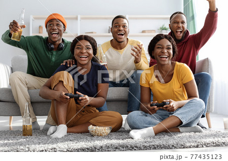 Joyful black fellows having fun at home Joyful black fellows having fun at home 77435123