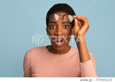 Confused Black Female Taking Off Glasses And Looking At Camera With Shock Confused Black Female Taking Off Glasses And Looking At Camera With Shock 77435215