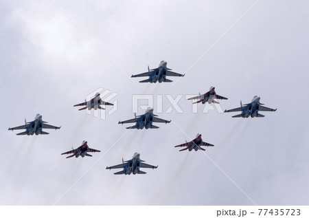 MOSCOW, RUSSIA - MAY 7, 2021: Avia parade in Moscow. group jet fighter aircraft MiG-35 and Su-30 in the sky on parade of Victory in World War II in Moscow, Russia MOSCOW, RUSSIA - MAY 7, 2021: Avia parade in Moscow. group jet fighter aircraft MiG-35 and Su-30 in the sky on parade of Victory in World War II in Moscow, Russia 77435723