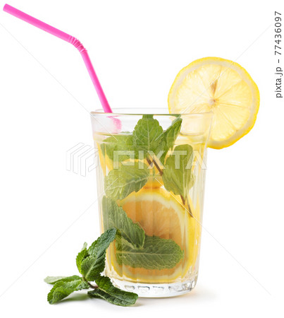 Glass of lemonade with cocktail straws and mint on a white background. Isolated 77436097