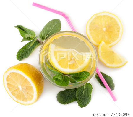 Glass of lemonade with cocktail straws and mint on a white background, isolated. Top view 77436098
