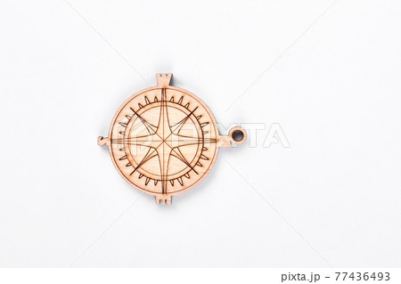 Cardboard compass on white background. 77436493