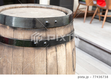 oak barrels light beige with a black hoop vertically on the background of a street cafe 77436738