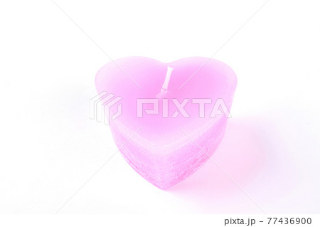 Pink candle in a form of heart. 77436900