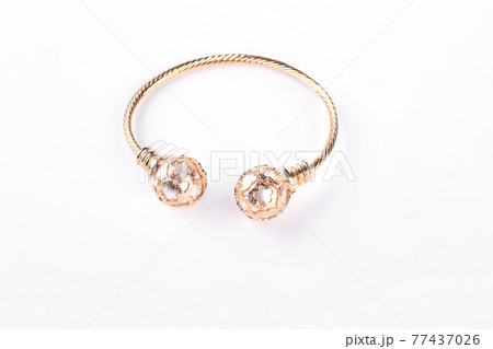 Gold bracelet on a white background. Gold bracelet on a white background. 77437026