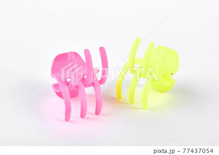 Woman plastic hair clips on white background. Woman plastic hair clips on white background. 77437054