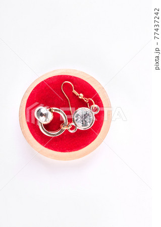 Earring with stone on red stand. Earring with stone on red stand. 77437242