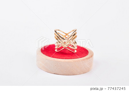 Luxury golden ring on red stand. 77437245