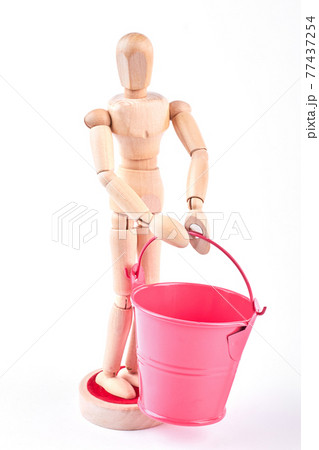 Wooden dummy with red bucket. 77437254