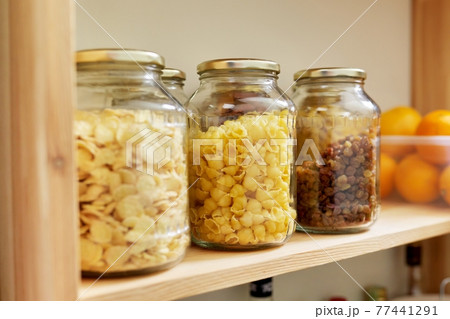 Kitchen pantry, wooden shelves with jars and containers with food, food storage. Kitchen pantry, wooden shelves with jars and containers with food, food storage. 77441291