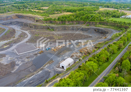 Large, open-pit mine showing the industrial exterior, ore mining quarry Large, open-pit mine showing the industrial exterior, ore mining quarry 77441397
