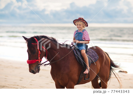 Kids riding horse on beach. Children ride horses. Kids riding horse on beach. Children ride horses. 77443343