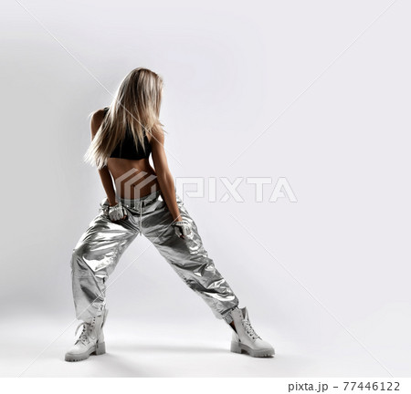 Sporty woman, dancer in loose fit silver pants 77446122