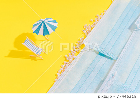 Summer vacation concept during pandemic. Social distance of people on beach. On yellow background, there are seashells and standing chazlongue and an umbrella from sun. Medical masks are depicted as Summer vacation concept during pandemic. Social distance of people on beach. On yellow background, there are seashells and standing chazlongue and an umbrella from sun. Medical masks are depicted as 77446218