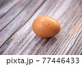 Close-up view of raw chicken eggs on wooden background. Eggs are often said to be the original superfood because of their many health benefits. 77446433