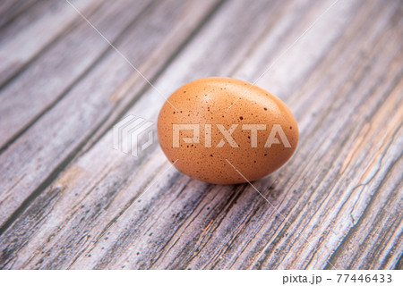 Close-up view of raw chicken eggs on wooden background. Eggs are often said to be the original superfood because of their many health benefits. Close-up view of raw chicken eggs on wooden background. Eggs are often said to be the original superfood because of their many health benefits. 77446433