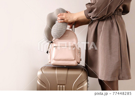 Closeup hands of travel woman holding backpack and stylish suitcase ready to business trip vacation Closeup hands of travel woman holding backpack and stylish suitcase ready to business trip vacation 77448285