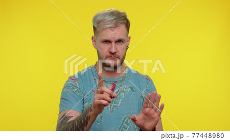 Bearded man warning with admonishing finger gesture, saying no, be careful, advice avoid danger 77448980