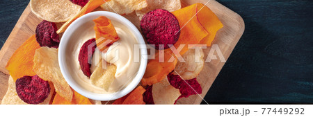 Vegetable chips with a homemade dip panoramic banner Vegetable chips with a homemade dip panoramic banner 77449292