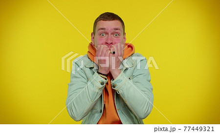 Young scared man biting nails, feeling worried nervous about serious troubles, stress and anxiety 77449321