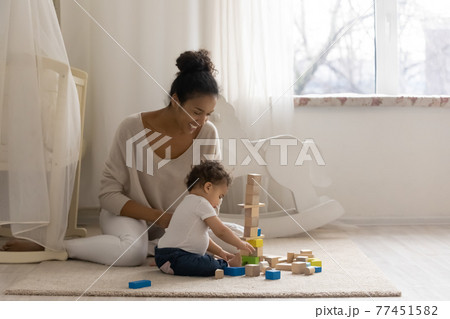 Loving African American mom play with little baby daughter Loving African American mom play with little baby daughter 77451582