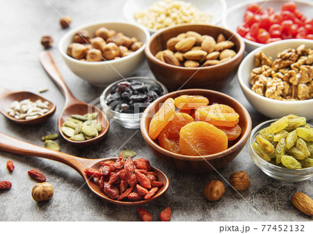 Bowls with various dried fruits and nuts 77452132