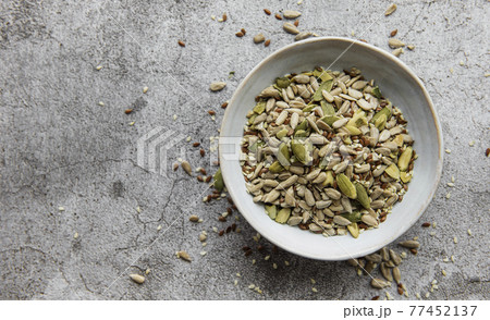 Mix different seeds for a healthy salad Mix different seeds for a healthy salad 77452137