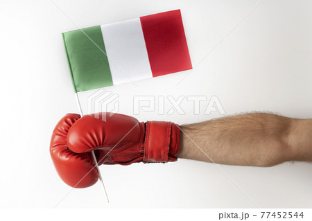 Boxing glove with Italian flag. Boxer holds...の写真素材 [77452544