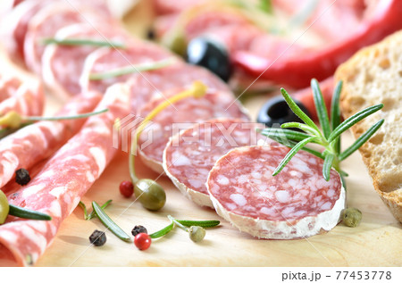 Snack with delicious French and Italian salami, spiced with rosemary and pepper Snack with delicious French and Italian salami, spiced with rosemary and pepper 77453778