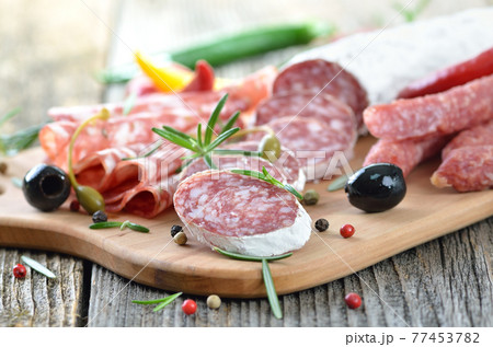 Snack with delicious French and Italian salami, spiced with rosemary and pepper Snack with delicious French and Italian salami, spiced with rosemary and pepper 77453782