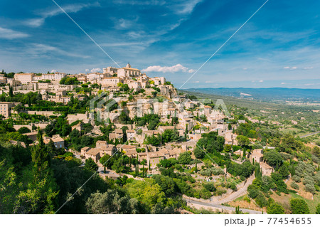 Gordes, Provence, France. Beautiful Scenic View Of Medieval Hilltop Village Of Gordes. Sunny Summer Sky. Famous Landmark. Gordes, Provence, France. Beautiful Scenic View Of Medieval Hilltop Village Of Gordes. Sunny Summer Sky. Famous Landmark. 77454655